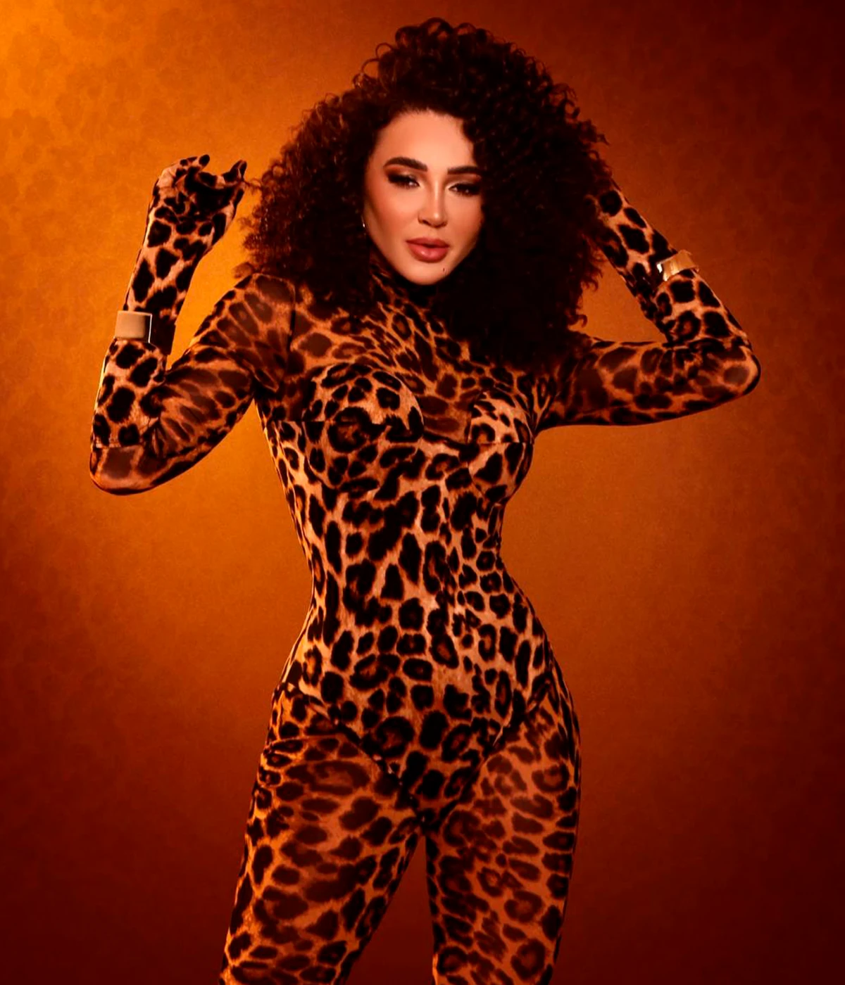 Editorial portrait of Larissa against a warm amber background